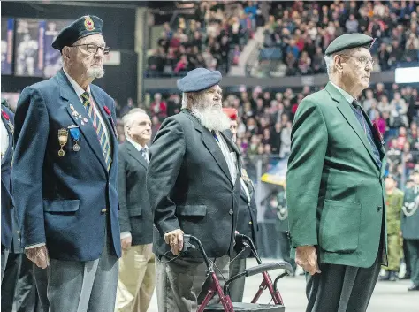  ?? PHOTOS: BRANDON HARDER ?? Lt.-Col. (retired) Robert Cade, right, leads the veterans’ company during the Remembranc­e Day service at Brandt Centre.