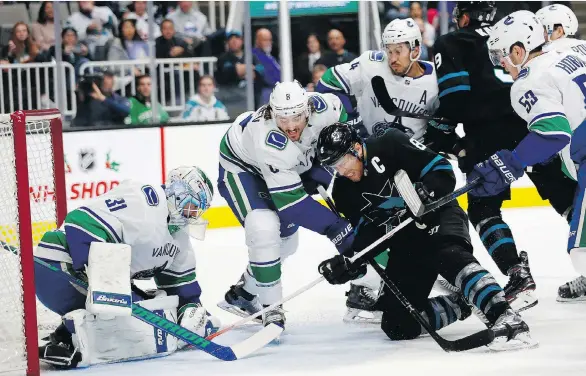  ?? JOSIE LEPE/THE ASSOCIATED PRESS ?? Canucks goalie Anders Nilsson makes a save with Sharks captain Joe Pavelski on his doorstep on Friday night at the SAP Center in San Jose, Calif.