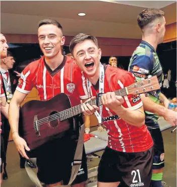  ?? ?? ON SONG: Declan Glass, right, enjoys that medal-winning feeling at Derry City.