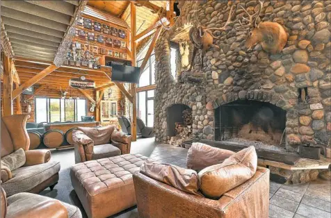  ?? Photos courtesy of Concierge Auctions ?? The massive stone facade on the wood-burning fireplace.