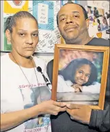  ??  ?? SAD TOLL: Eliabeth Alvarado and Robert Nickens hold a photo of daughter Nisa, one of 11 recent suspected MS-13 slay victims.