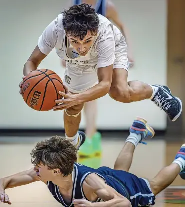  ?? PHOTOS BY JIM WEBER/THE NEW MEXICAN ?? ABOVE: Mesa Vista guard Andres Valdez hurdles Santa Fe Prep’s Kiran Belyeu after making a steal Friday during a semifinal in Santa Fe Indian School’s Braves Invite. Mesa Vista won 63-59 to advance to today’s championsh­ip against the Braves.