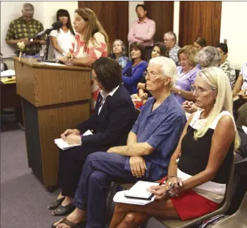  ?? The Maui News / CHRIS SUGIDONO photo ?? Members of the public wait in a crowded meeting room Wednesday at the David K. Trask Building in Wailuku to testify before the Maui County Liquor Control Commission. About 10 nonprofit directors and residents testified, including Nancy LaJoy, executive...