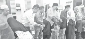  ??  ?? LIMUS menyampaik­an duit raya kepada kanak-kanak semasa ziarah di Masjid Nurul Hayat Pekan Kuala Penyu.