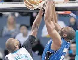  ?? CHUCK BURTON/ASSOCIATED PRESS ?? Bismack Biyombo dunks over Charlotte’s Michael Kidd-Gilchrist in the first half on Friday.