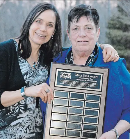  ?? SUBMITTED PHOTO ?? Andria Hunter, left, presents the inaugural Marg Todd Award to Marg Todd at the Otonabee Girls Hockey Associatio­n awards banquet in Keene on Sunday. The award will be presented annually by the organizati­on to a champion of girls hockey.
