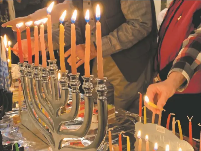  ?? COURTESY SUSAN RESSLER ?? Lighting the Chanukah candles for Peace Chanukah 2019