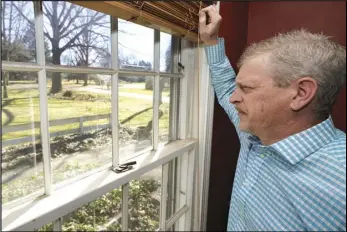  ?? ASSOCIATED PRESS ?? Matt Moorhead looks out his window March 2 in Warren, Ohio. When General Motors ended a half-century of building cars in Ohio’s blue collar corner, 1,600 workers had to decide whether to accept the automaker’s offer to move to another factory. Moorhead went by himself in the summer of 2019 to Lansing where he paid for an apartment on top of his mortgage back in Ohio.