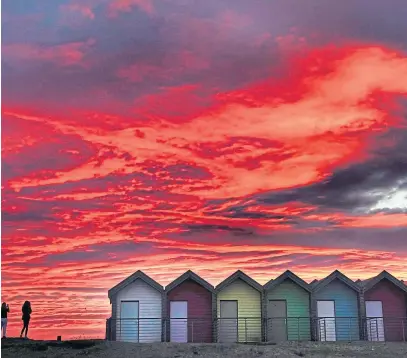  ??  ?? Colourful beach huts stand in front of the stunning red sky at sunrise in Blyth, Northumber­land, yesterday morning. Picture by Owen Humphreys /PA Wire.