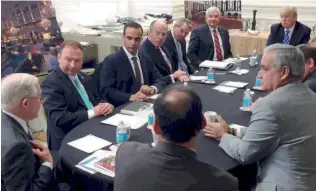  ??  ?? George Papadopoul­os (third from left) sits at a table with then-US presidenti­al candidate Donald Trump and others during a meeting in Washington in this photo that was posted on Trump’s Twitter account on March 31.