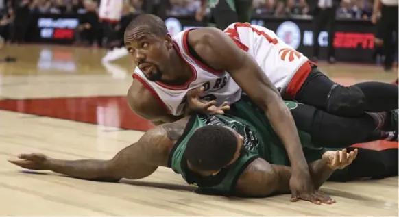  ?? RICHARD LAUTENS/TORONTO STAR FILE PHOTO ?? Serge Ibaka, falling on former Raptor Amir Johnson when the teams collided in February, has landed in a good place in the Toronto rotation — the culminatio­n of a months-long courtship.