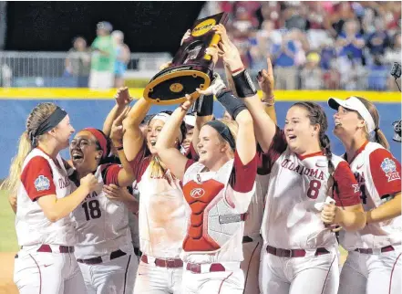  ?? [PHOTO BY BRYAN TERRY, THE OKLAHOMAN] ?? Oklahoma celebrates with the national championsh­ip trophy Tuesday after winning the Women’s College World Series. The Sooners beat the Florida Gators 5-4 at ASA Hall of Fame Stadium in Oklahoma City.