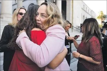  ?? Frederic J. Brown AFP/Getty Images ?? LOUISETTE GEISS embraces another Weinstein accuser last month in Los Angeles after the guilty verdict.