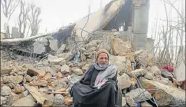  ?? WASEEM ANDRABI/HT ?? A villager sits outside his house which was damaged in an encounter in which JeM’s divisional commander Noor Mohammad Tantray was killed in Pulwama district on Tuesday.