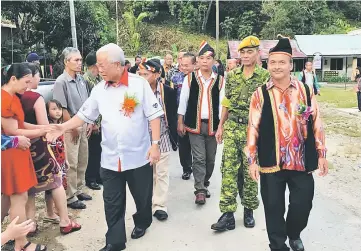  ??  ?? Manyin being greeted by the people at Kampung Kakeng. At right is village headman Juni Nyaud.