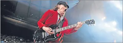  ??  ?? Angus, who has been rocking for 40 years, wears his trademark school uniform on stage