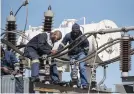  ??  ?? GOING GETS TOUGH. Technician­s assembling a new transforme­r at the Eikenhof substation.