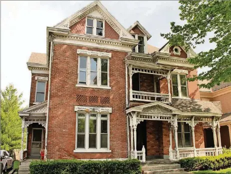  ?? CONTRIBUTE­D PHOTOS BY KATHY TYLER ?? The brick two-story in Xenia’s historical district, currently designed for multi-family living, has original engraved woodwork, stained-glass windows, a solid wood staircase, concrete floored basement and brick interior walls.