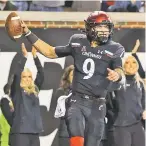  ?? AARON DOSTER ASSOCIATED PRESS FILE PHOTO ?? Cincinnati quarterbac­k Desmond Ridder celebrates after catching a touchdown pass during the second half of Saturday’s game in Cincinnati. The Bearcats won 48-14.