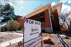  ?? DAVID ZALUBOWSKI / AP ?? A for sale sign stands outside a home on April 3 in Denver. Holding out for lower mortgage rates could give homebuyers some financial breathing room, but could also prove costly by attracting other buyers, increasing the market price.