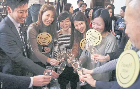 ??  ?? Office workers in Tokyo area toast during the start of ‘Premium Friday’ government campaign yesterday.