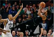  ?? AP PHOTO BY JIM MONE ?? Minnesota Timberwolv­es’ Derrick Rose, right, takes a fall-back shot as Utah Jazz’s Dante Exum defends during the first half of an NBA basketball game Wednesday, Oct. 31, in Minneapoli­s.