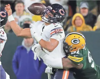  ?? MARK HOFFMAN/MILWAUKEE JOURNAL SENTINEL ?? Packers linebacker Preston Smith forces a fumble by Bears quarterbac­k Justin Fields during the third quarter Sunday.