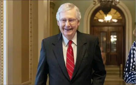  ?? J. SCOTT APPLEWHITE — THE ASSOCIATED PRESS ?? Senate Majority Leader Mitch McConnell, R-Ky., smiles after vote on a hard-won budget deal that would permit the government to resume borrowing to pay all of its obligation­s and would remove the prospect of a shutdown in October, at the Capitol in Washington, Thursday.