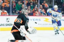  ?? MATT SLOCUM/AP ?? Flyers goalie Carter Hart, left, blocks a shot during the third period against the Sabres on Friday night at Wells Fargo Center.