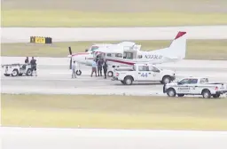  ?? WPTV ?? Emergency personnel surround a Cessna plane May 10 at Palm Beach Internatio­nal Airport in West Palm Beach, Fla., after a passenger with no experience was able to land it safely.