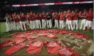  ?? MARCIO JOSE SANCHEZ - THE ASSOCIATED PRESS ?? Members of the Los Angeles Angels place their jerseys with No. 45 in honor of pitcher Tyler Skaggs on the mound after a combined no-hitter against the Seattle Mariners during a game Friday, July 12, 2019, in Anaheim, Calif. The Angels won 13-0.