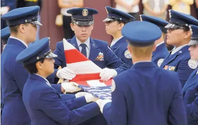  ?? GREG SORBER/JOURNAL ?? Air Force JROTC cadets ceremoniou­sly fold the flag during an assembly at Valley High School last week to honor shop class students who made wooden urns for the remains of indigent and unclaimed veterans in Bernalillo County.