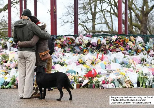  ??  ?? People pay their respects by the floral tributes left at the band stand in Clapham Common for Sarah Everard