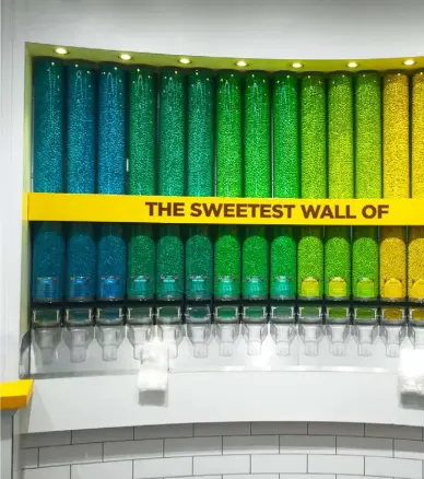  ??  ?? Sweet spot: part of the ‘world’s biggest candy wall’ at M&M’s World London, where customers can select chocolate dragées in myriad colours and flavours