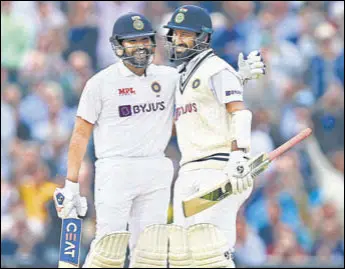  ?? AFP ?? Rohit Sharma (L) and Cheteshwar Pujara stitched together a 153-run stand for the second wicket on Day 3 of the fourth Test at the Oval on Saturday.