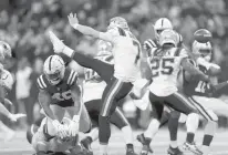  ?? AARON DOSTER/AP ?? The Colts’ Matthew Adams, right, blocks a punt by tht Patriots’ Jake Bailey on Saturday night in Indianapol­is. The Colts’ E.J. Speed ran the ball back for a touchdown.