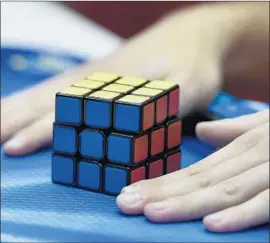  ?? Martin Meissner Associated Press ?? THE TWO algorithms typically can solve a Rubik’s Cube within 30 moves, which is less than or equal to systems that use human knowledge, researcher­s said.