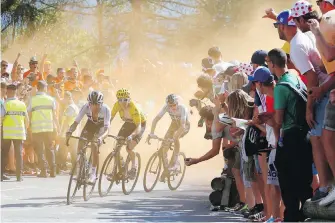  ??  ?? Colombia’s Egan Arley Bernal Gomez, Britain’s Geraint Thomas, wearing yellow jersey, and Britain’s Chris Froome climb Alpe d’huez during the 12th stage of the Tour de France on Thursday.