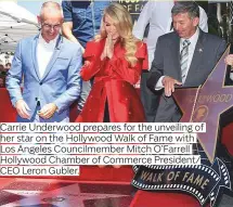  ??  ?? Carrie Underwood prepares for the unveiling of her star on the Hollywood Walk of Fame with Los Angeles Councilmem­ber Mitch O’FarrellHol­lywood Chamber of Commerce President/ CEO Leron Gubler.