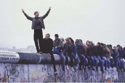  ??  ?? Ian Kershaw lived near the Berlin Wall in 1989 but that didn’t necessaril­y make analysing its fall (pictured here) any easier