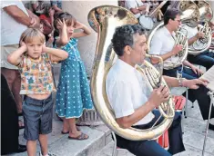  ??  ?? Children cover their ears as the sousaphone players get going at a concert in Croatia