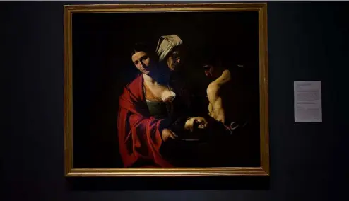  ?? AP Photo ?? A painting called "Salome with the Head of John the Baptist", by Caravaggio is displayed at the Royal Collection­s Gallery in Madrid