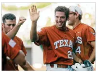  ?? AMERICANST­ATESMAN 2003 ?? Longhorns pitcher Huston Street high-fives teammates during a 2003 NCAA Tournament game. He was a three-year All-American with 41 saves, the school’s alltime record.