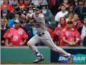  ?? Charles Krupa / The Associated Press ?? Houston’s Josh Reddick hits an RBI single in Game 4 of baseball’s American League Division Series.