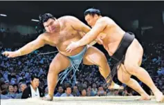  ?? THE ASAHI SHIMBUN VIA GETTY IMAGES ?? Hakuho Sho (right) pushes Takayasu Akira to achieve his record 1,048th career win during the Grand Sumo Nagoya Tournament at Aichi Prefecture Gymnasium in Japan, on July 21, 2017.