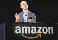  ?? Ted S. Warren / Associated Press 2014 ?? Produce at Whole Foods, top. Amazon’s Jeff Bezos, above, has announced his company is buying the chain.