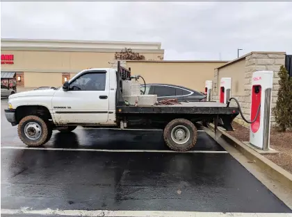  ?? FRECKLETAN/REDDIT ?? Trucks blocking Tesla Supercharg­er stations are the latest twist in the resistance to advancemen­ts in automotive technology.