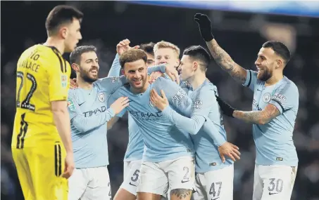  ??  ?? Manchester City’s Kyle Walker (third left) celebrates scoring his side’s eighth goal of the game with team-mates last night.