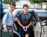  ?? RICHARD GRAULICH / THE PALM BEACH POST 2016 ?? Austin Harrouff is escorted by detectives after leaving the hospital Oct. 3, 2016. His mother said he had agreed to go to counseling in the hours before the killings.