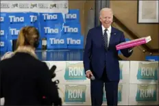  ?? CAROLYN KASTER — THE ASSOCIATED PRESS ?? President Joe Biden holds a box of doughnuts during a grassroots volunteer event with the Oregon Democrats at the SEIU Local 49in Portland, Ore. Friday.